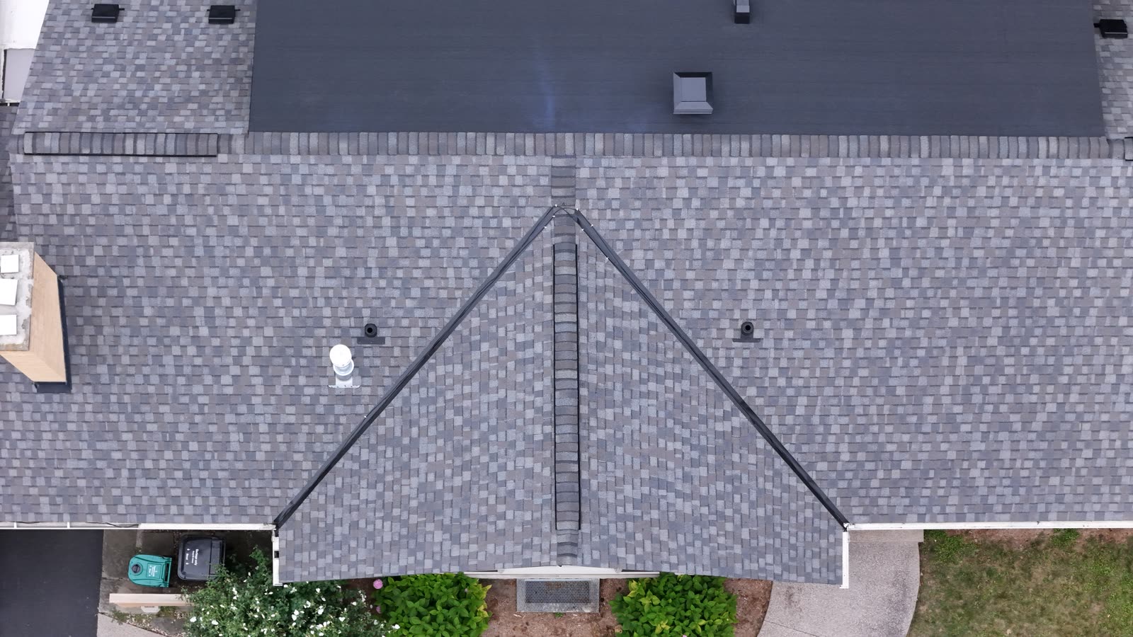 A finished Max Def Driftwood shingle roof photographed from directly above, with a front gable meeting the main roof in two open valleys